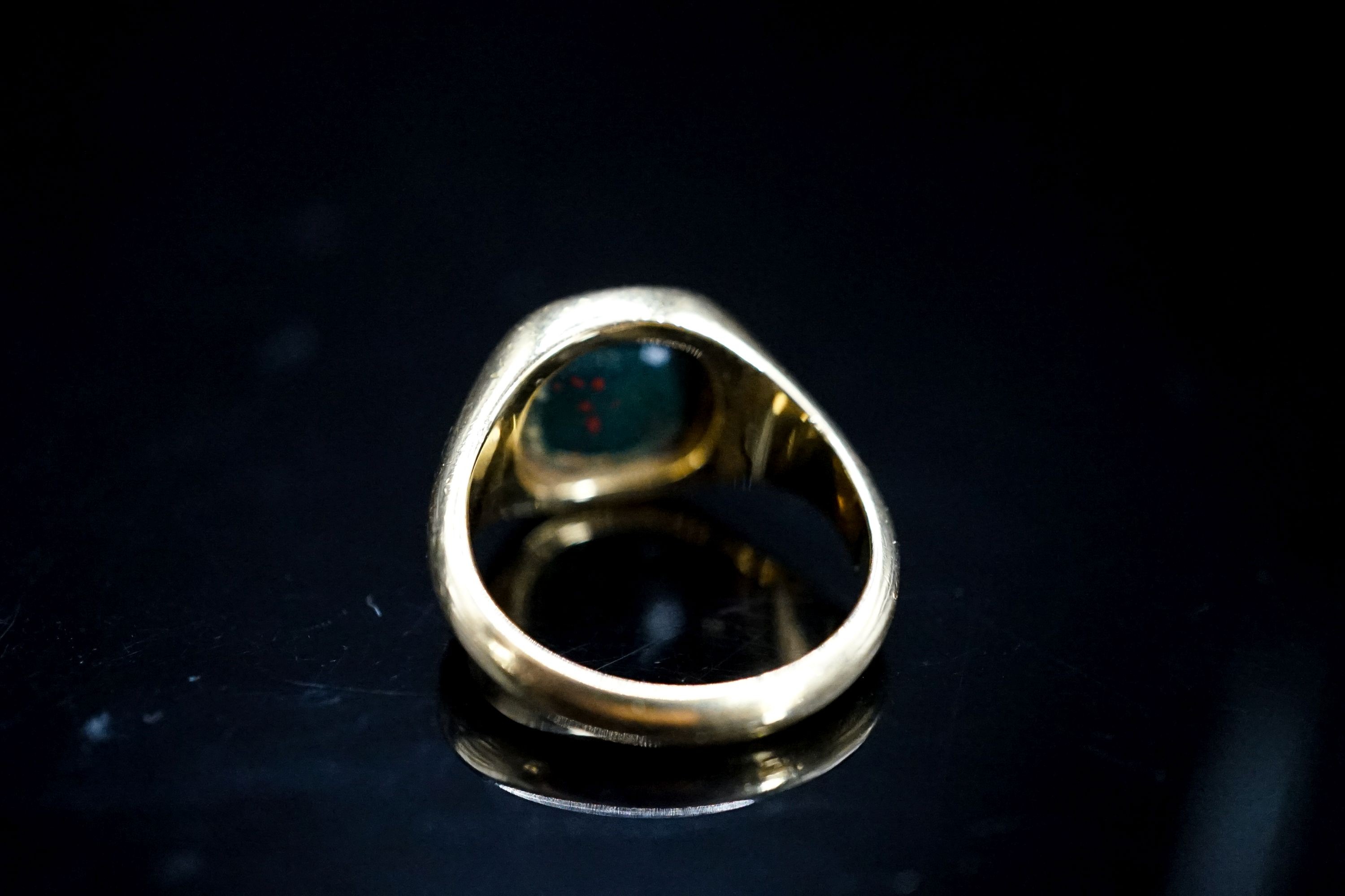 A mid 20th century 18ct gold and carved bloodstone set signet ring, size N, gross 8.3 grams.